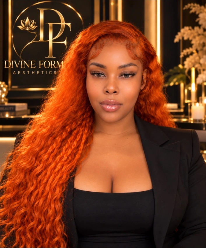 Delisha in a black blazer with copper waves, pictured with Divine Form Aesthetics branding